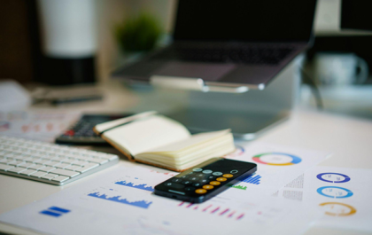 Person taking notes while reviewing debt consolidation options and financial planning documents