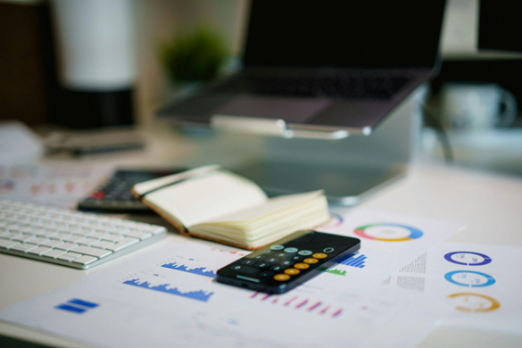 Person taking notes while reviewing debt consolidation options and financial planning documents